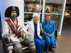 Silvergate guests Katie and Iris stop for a photo at the "Real Pirates" exhibit entrance.