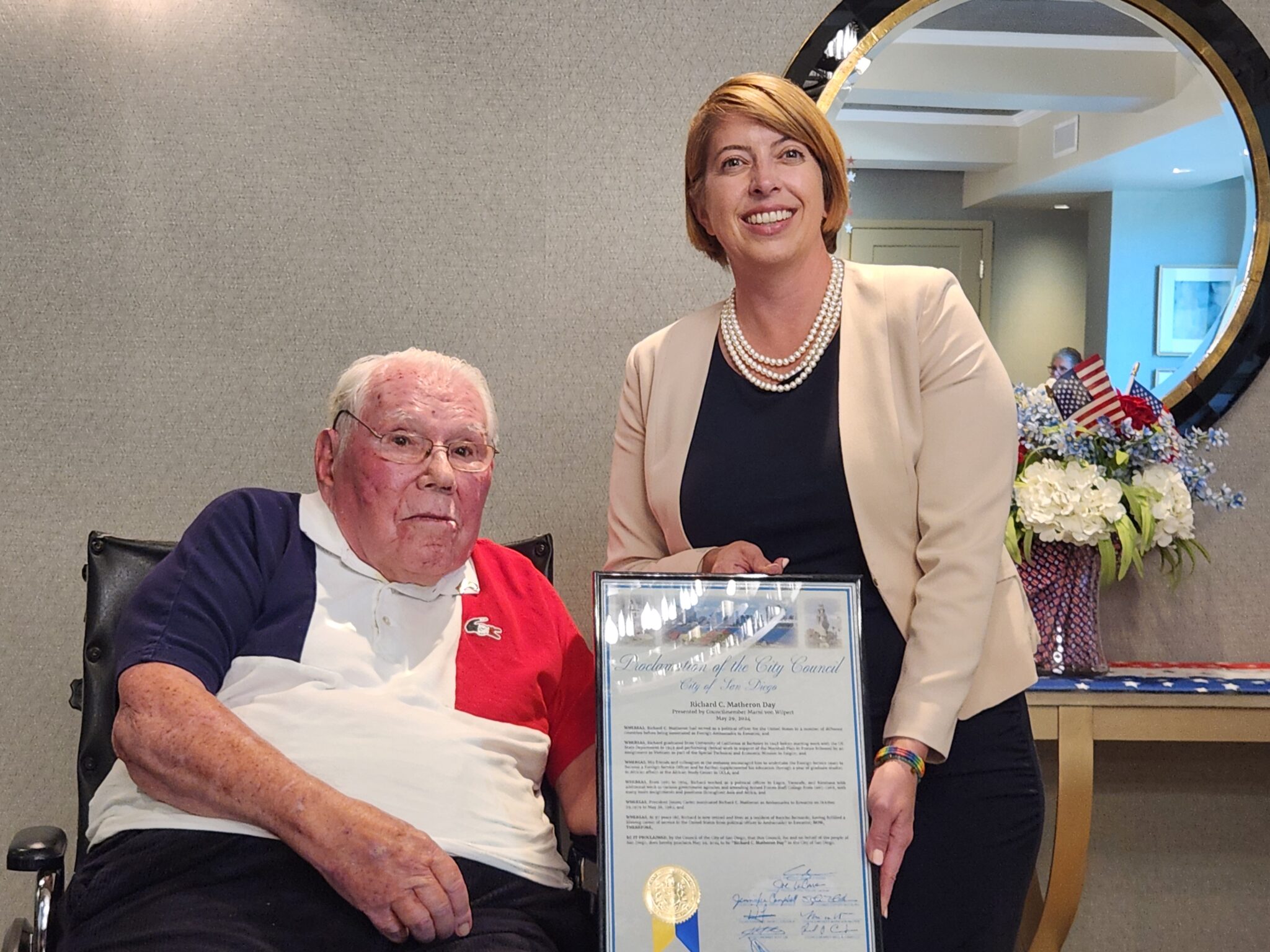 San Diego City Council Member Marni Von Wilpert presents a plaque commemorating May 29th as Richard C. Matheron Day, in honor of the former Ambassador and current Silvergate resident.